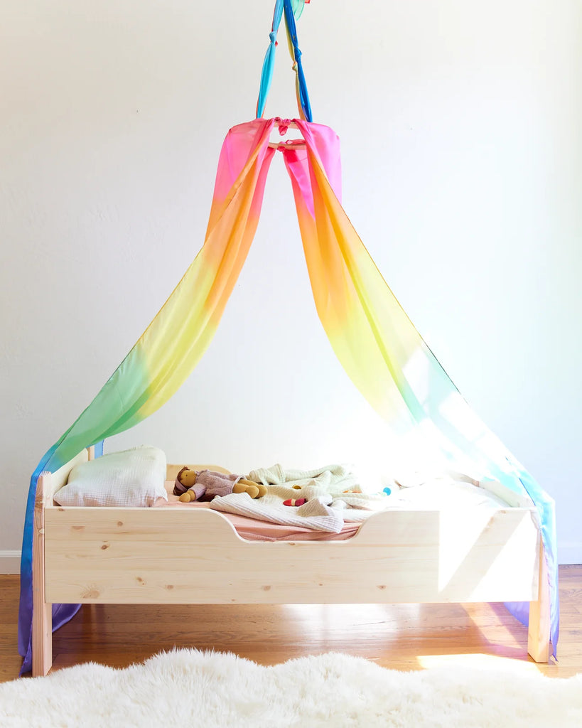 Sarah's Silks Wooden Canopy Ring With Rainbow Play Silk Over Bed 
