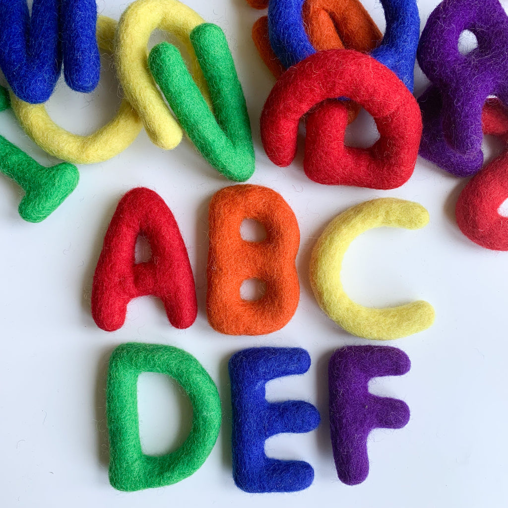 A felt alphabet set in rainbow colours, chunky letters for babies to play with or garland available from a small shop in Canada 