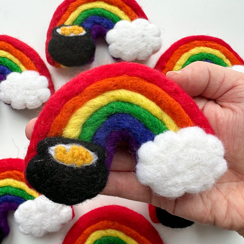 large felt pot of gold rainbow with a white cloud on one end and a pot of gold on the other. 