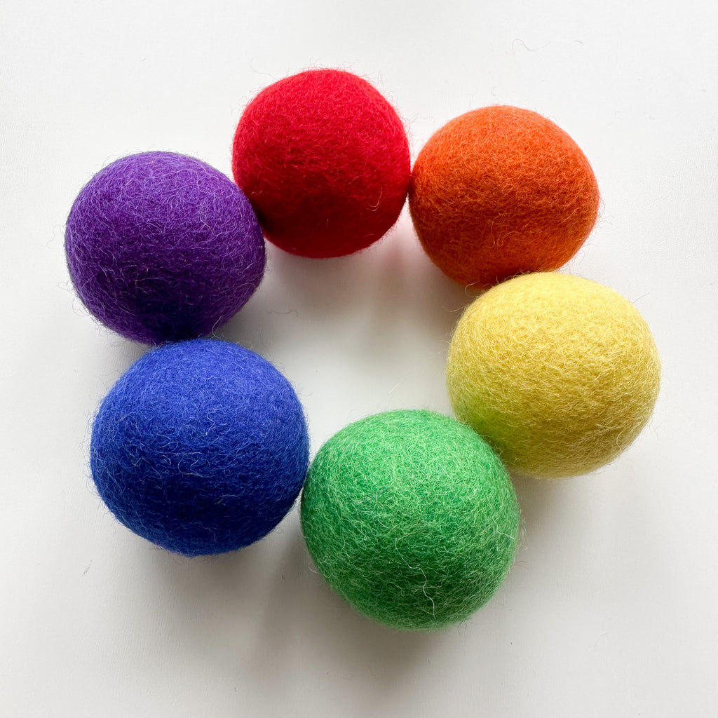 Large felt balls for toddlers in rainbow colours for color sorting, matching and play 